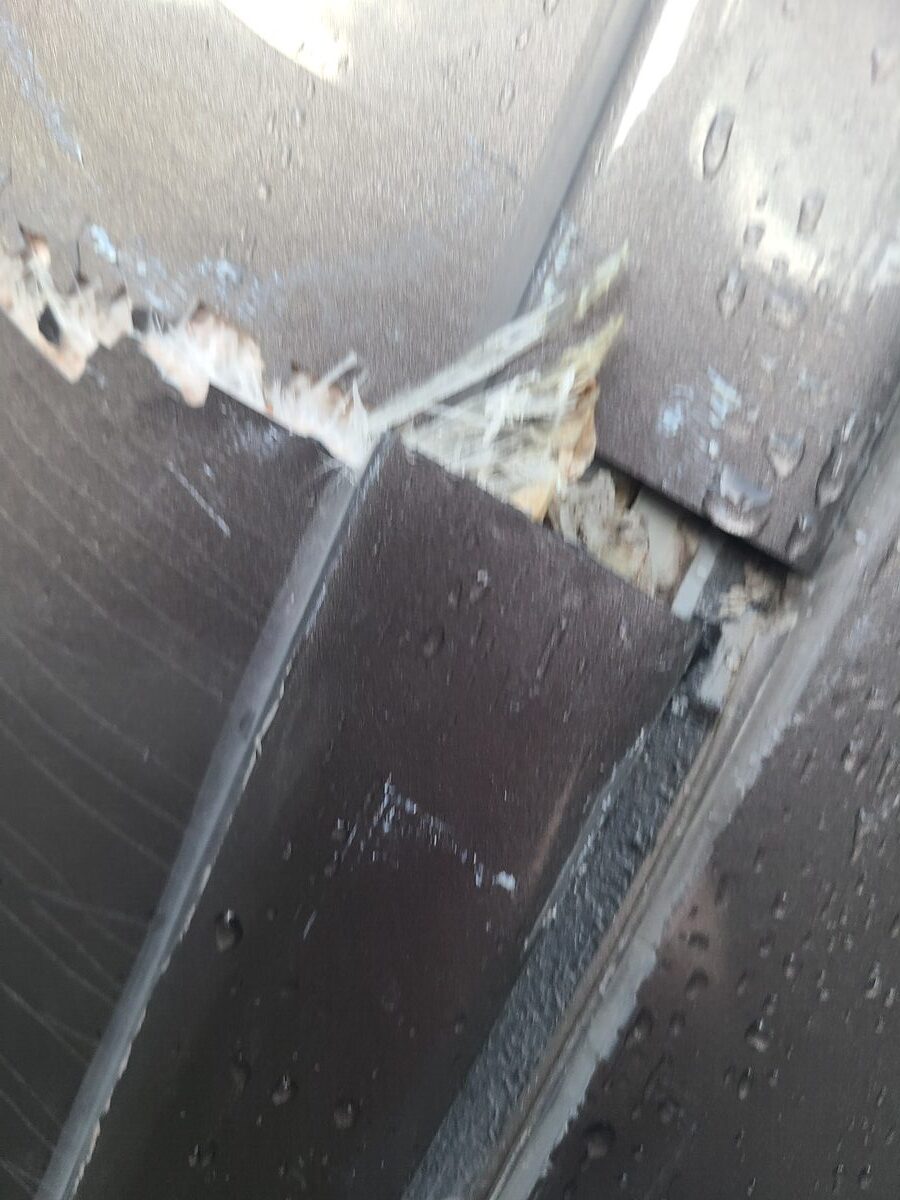 Additional damage detail on the RV rear fiberglass cap — ragged tear along the seam