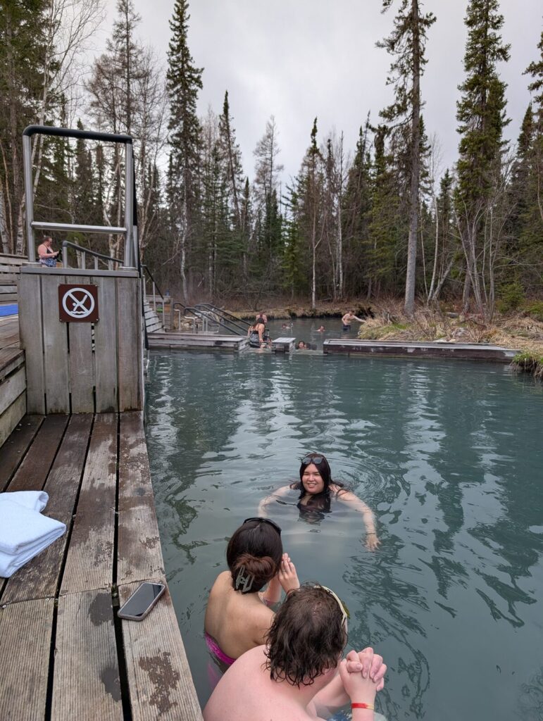 Swimmers enjoying Liard Hot Springs natural pool in British Columbia Canada