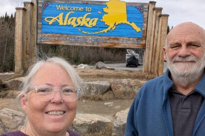 Phyllis and Mike at the Welcome to Alaska sign on the Historic Alaska Highway