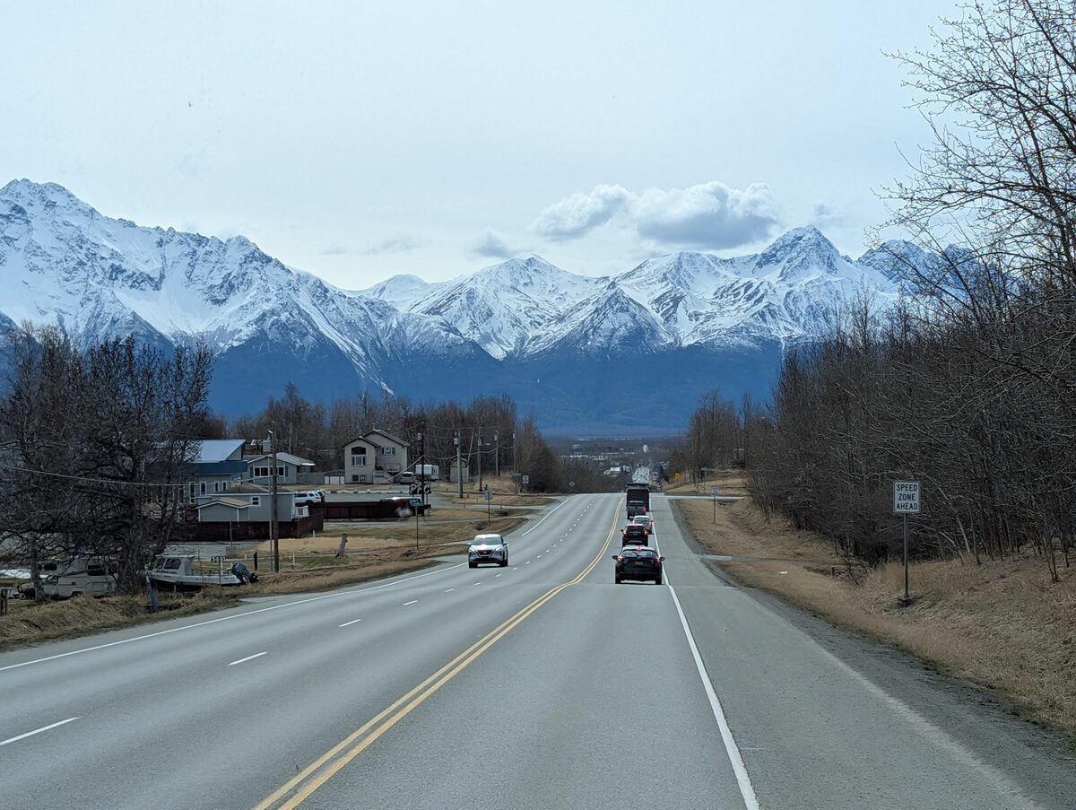 Driving into Palmer Alaska with dramatic snow-capped Chugach Mountains