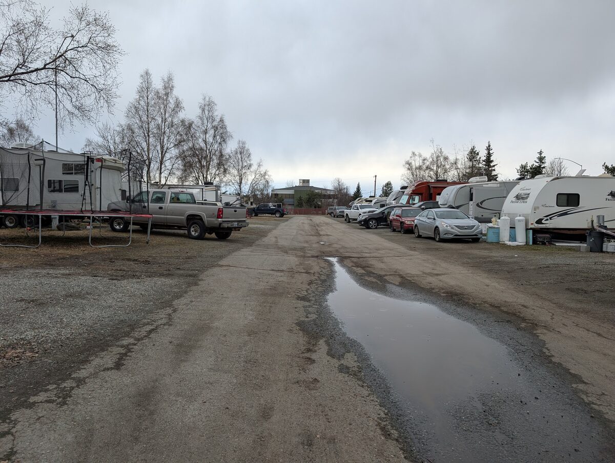Muddy gravel RV park in Anchorage, Alaska — our home base for the summer of 2025