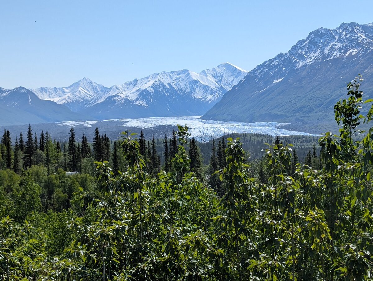Matanuska Glacier flowing between snow-capped mountains in the Matanuska Valley, Alaska
