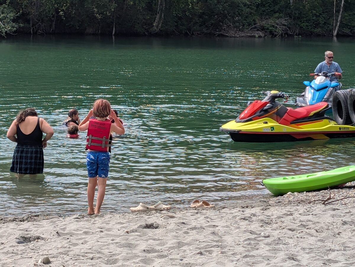 Kids and grandkids swimming and jet skiing on the lake at Sherry Gates' 80th birthday celebration Salcha, Alaska