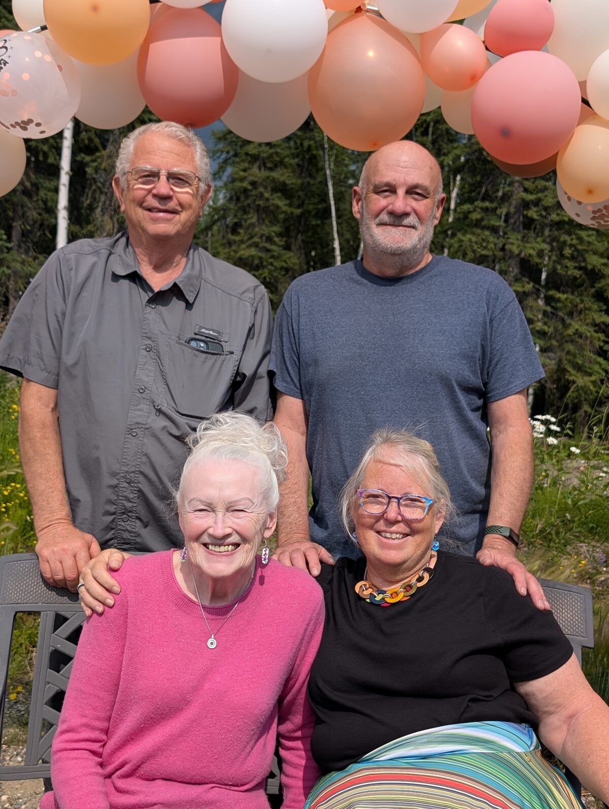 Gary and Sherry Gates with Mike and Phyllis at Sherry's 80th birthday party, Salcha Alaska, under pink balloon arch