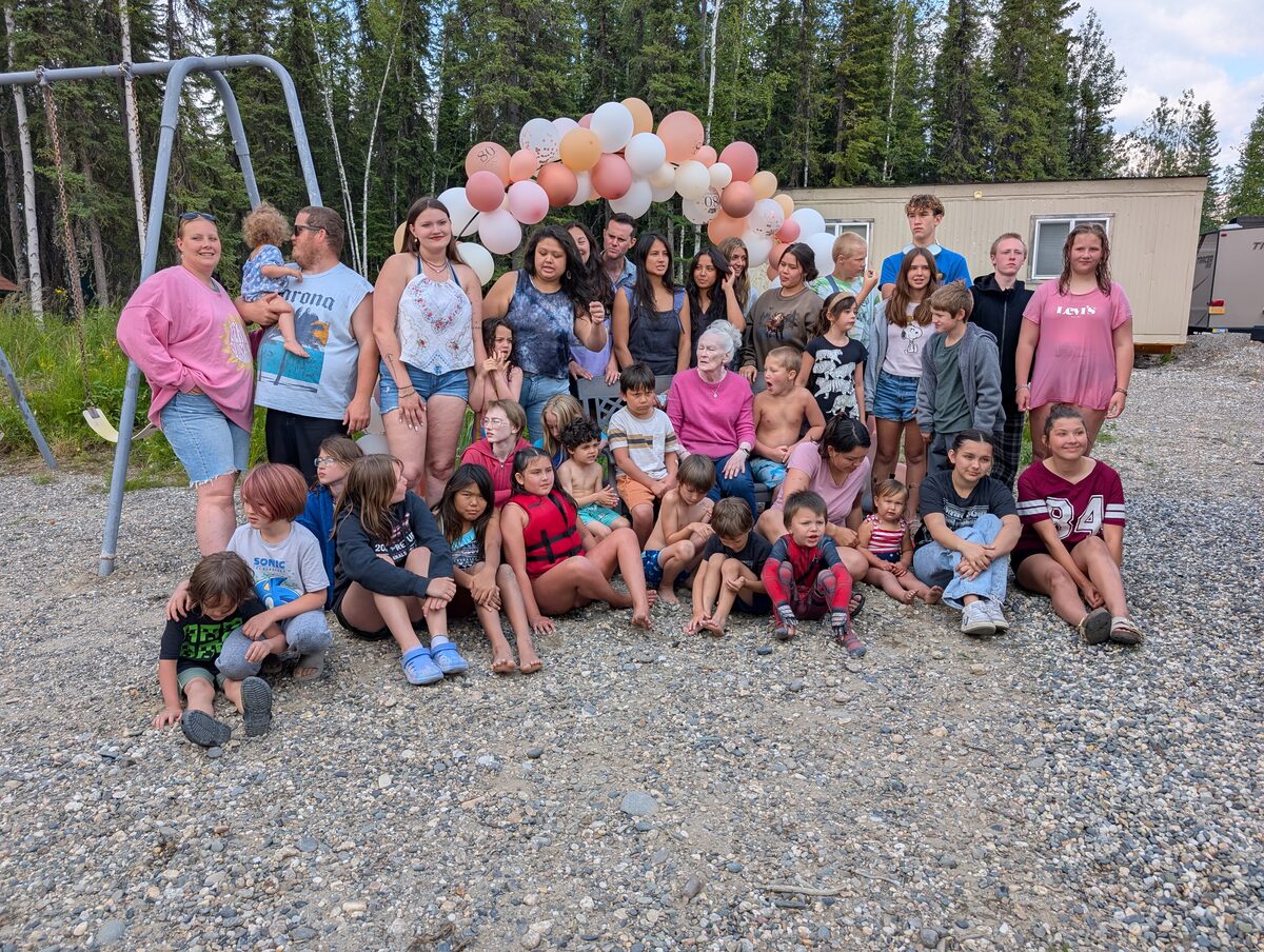 Large multi-generational family group photo at Sherry Gates' 80th birthday party near Fairbanks, Alaska