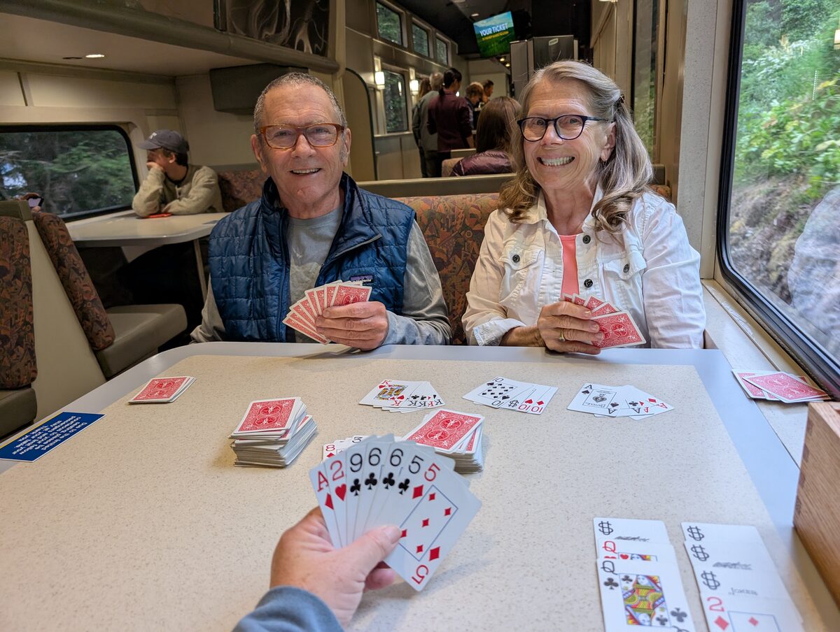 Kathleen and Roger playing cards with Phyllis and Mike aboard the Alaska Railroad to Seward