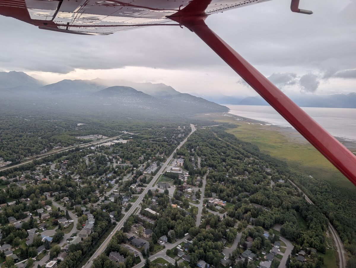 Aerial view of Anchorage from the floatplane window, Cook Inlet and mountains visible