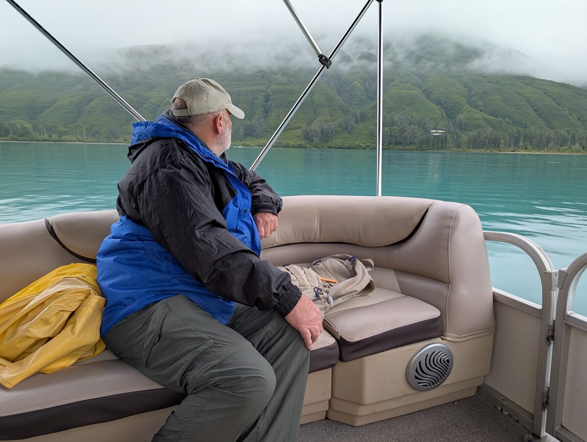 Mike taking in the stunning turquoise waters of Lake Clark from the bear viewing boat