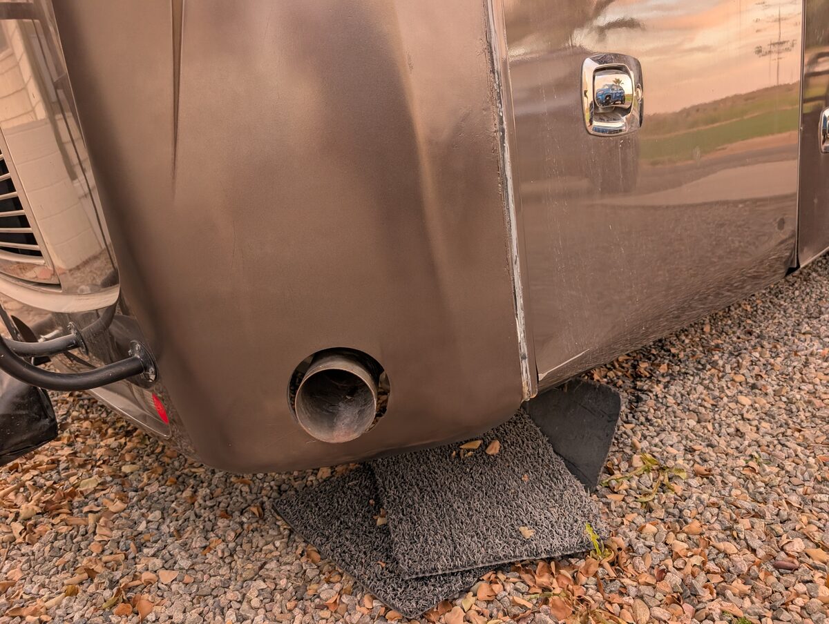 Completed fiberglass repair on the RV rear cap — smooth finish, you'd never know it happened